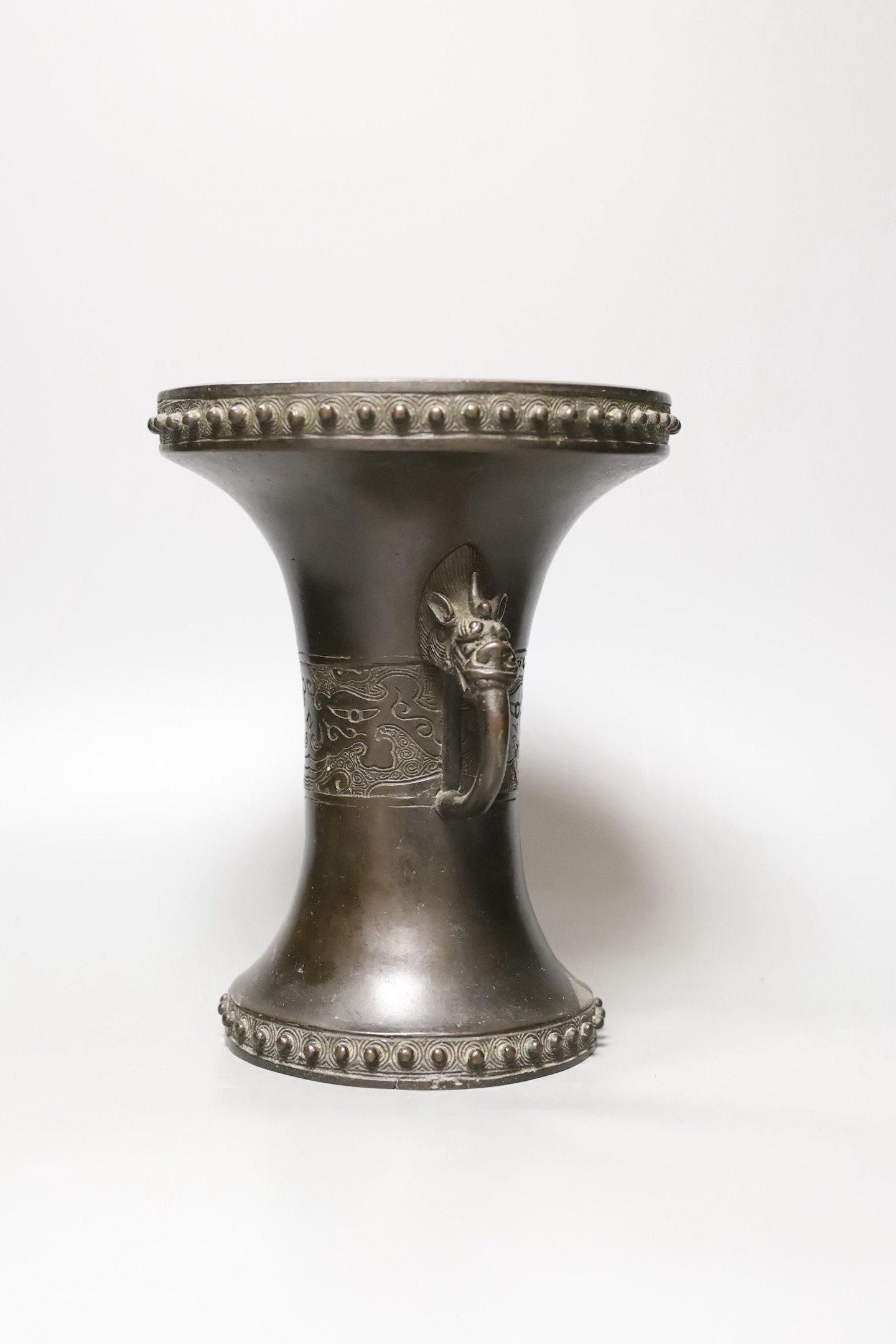 A Chinese or Japanese archaistic bronze two handle vase, 19th century, 24 cms high.